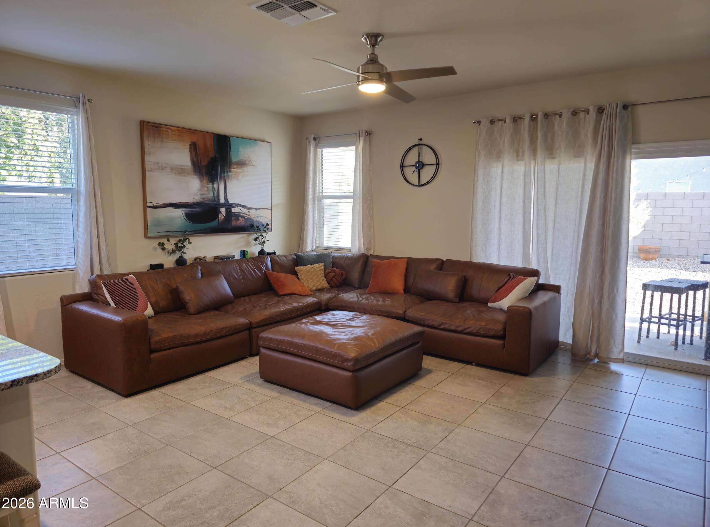 9434 Cotton Road Florence, AZ 85132 - Photo 8 of 25 a living room with furniture and a flat screen tv