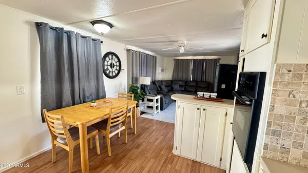 a kitchen with stainless steel appliances kitchen island granite countertop a refrigerator sink and white cabinets