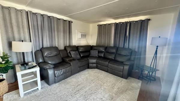 a bedroom with furniture and a flat screen tv