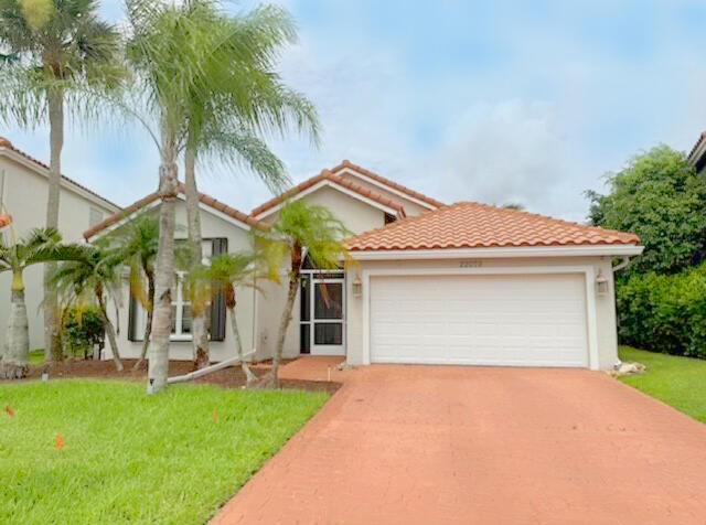 22079 Altona Drive Boca Raton, FL 33428 - Photo 1 of 8 front view of house with a yard and palm trees