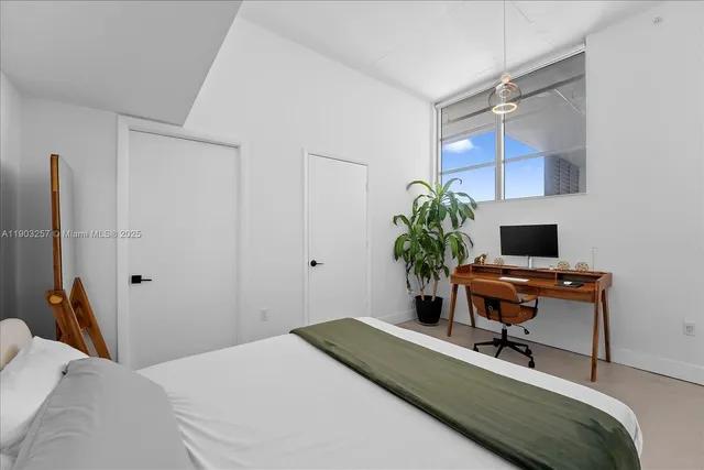 a bedroom with a bed and a desk