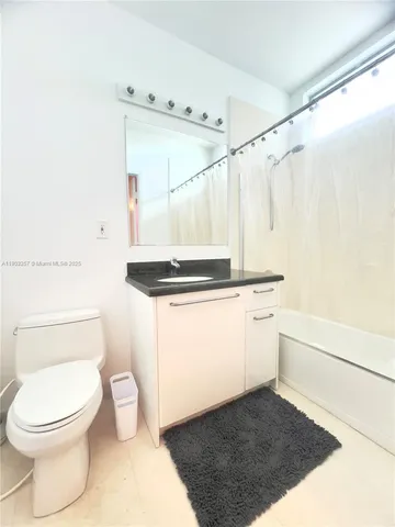 a bathroom with a toilet a sink and a shower