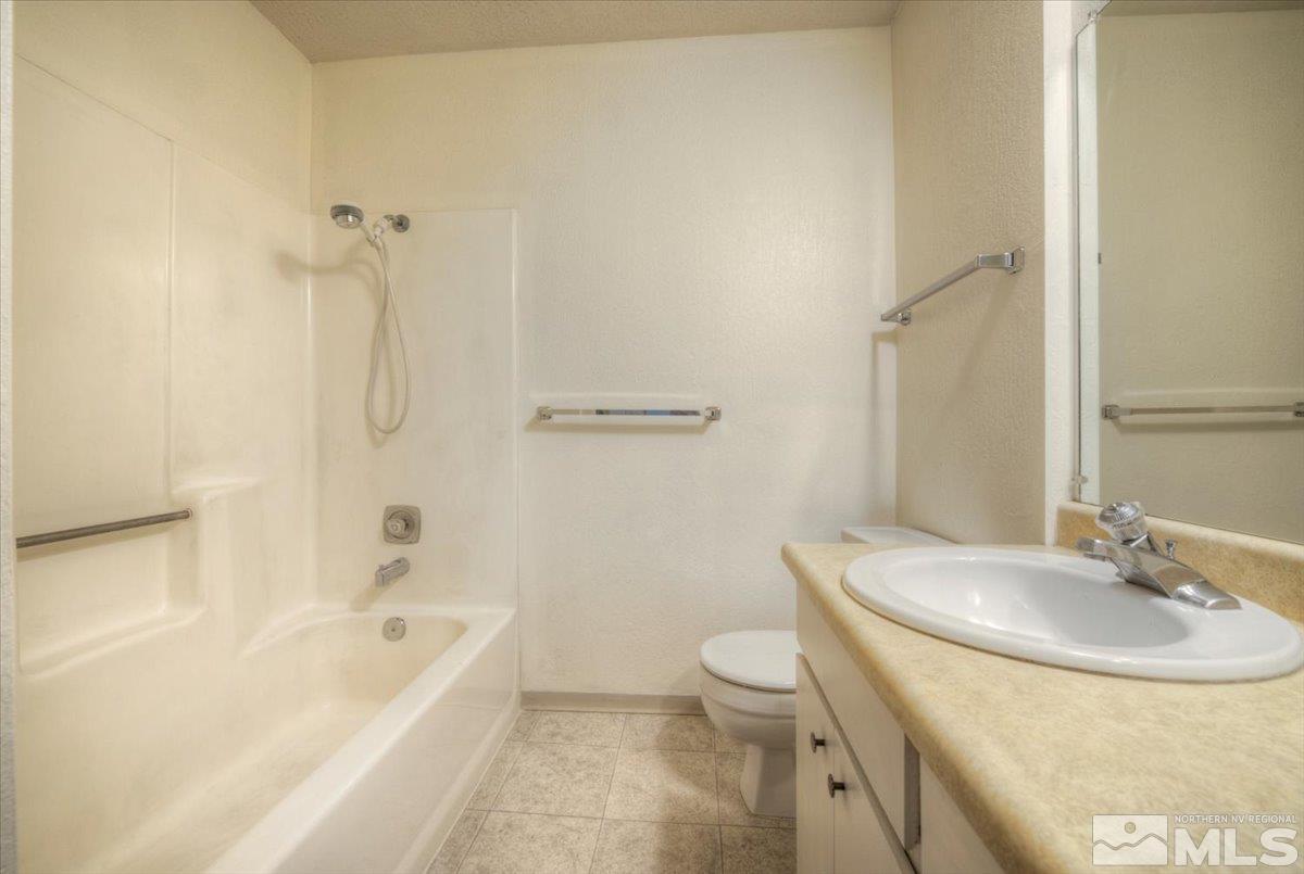 4658 Rio Poco Road Reno, NV 89502 - Photo 17 of 31 a bathroom with a sink a toilet and shower