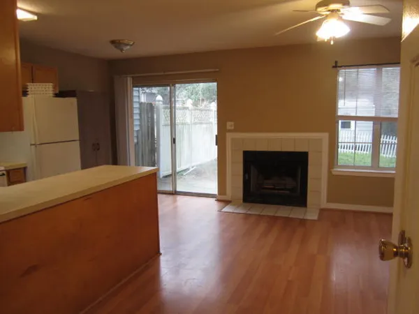 a view of a livingroom with a fireplace and window