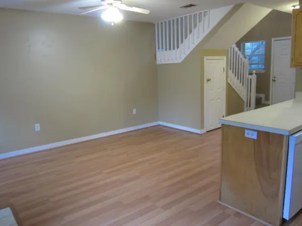 a view of an empty room with wooden floor