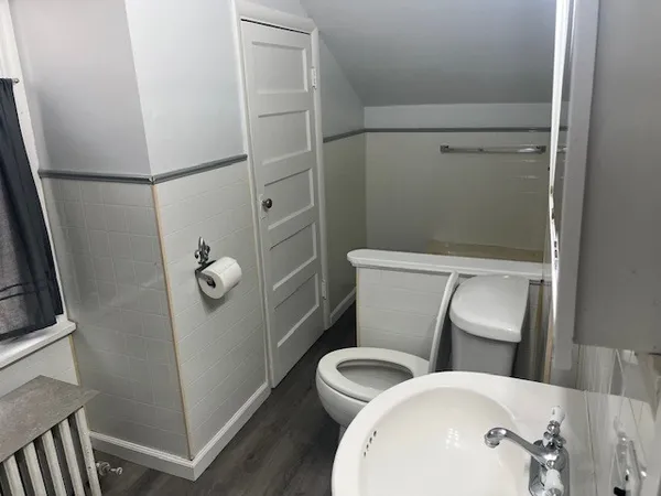 a white toilet sitting next to a bathroom sink