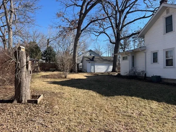 a view of a yard with a large tree