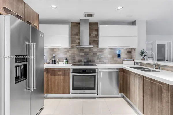 a kitchen with a sink stove and refrigerator