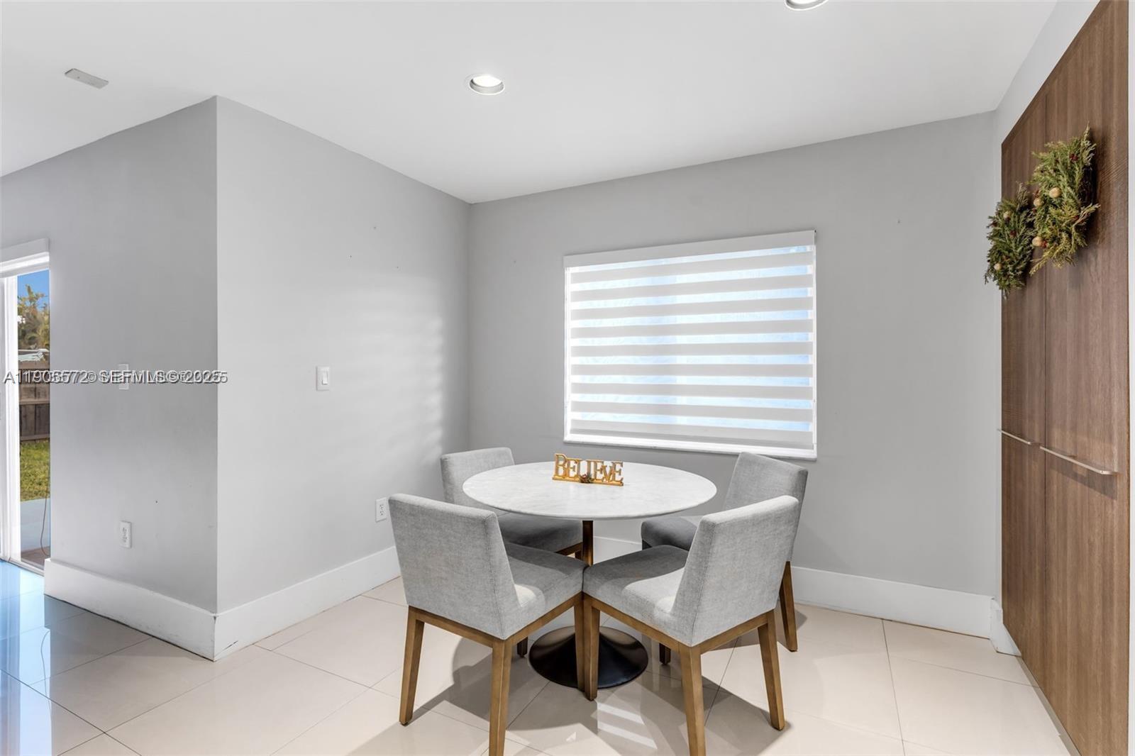 14206 Southwest 164th Terrace Miami, FL 33177 - Photo 13 of 58 a view of a dining room with furniture and a window