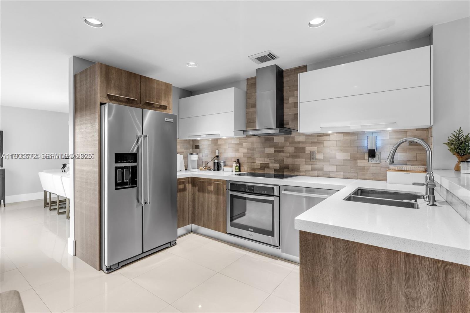 14206 Southwest 164th Terrace Miami, FL 33177 - Photo 15 of 58 a kitchen with refrigerator cabinets and a sink