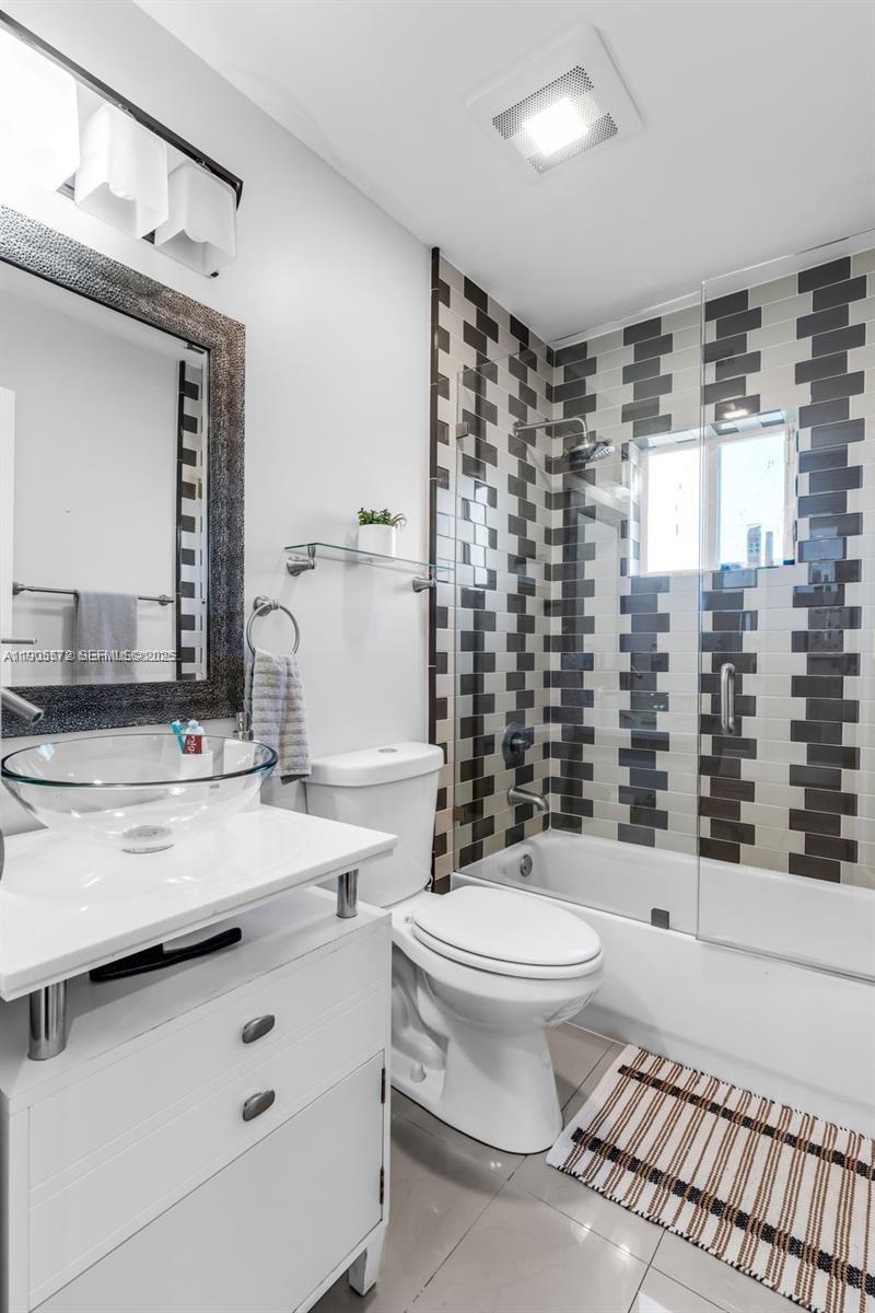 14206 Southwest 164th Terrace Miami, FL 33177 - Photo 22 of 58 a bathroom with a sink toilet and shower