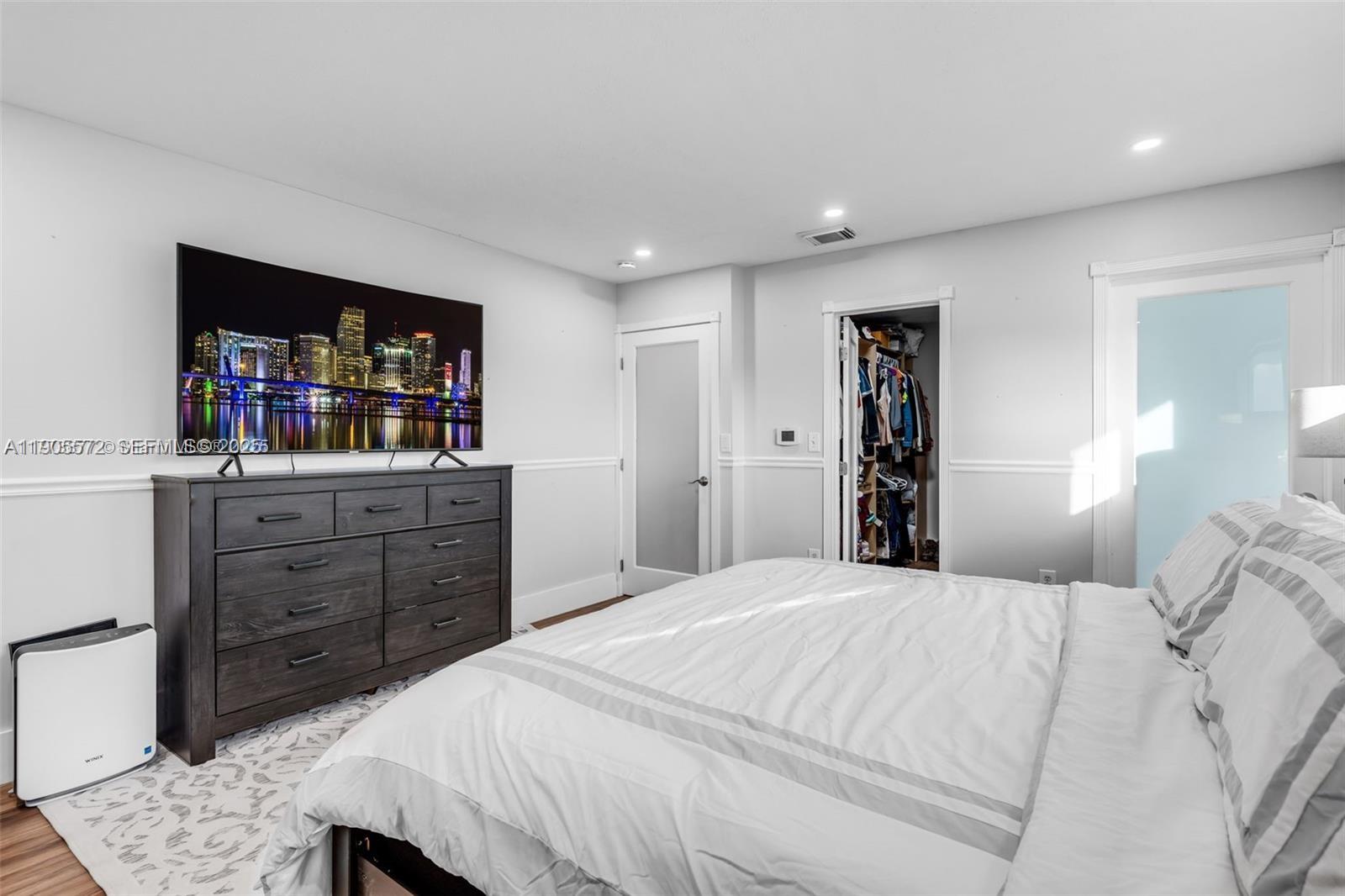 14206 Southwest 164th Terrace Miami, FL 33177 - Photo 28 of 58 a bedroom with a bed and a cabinets