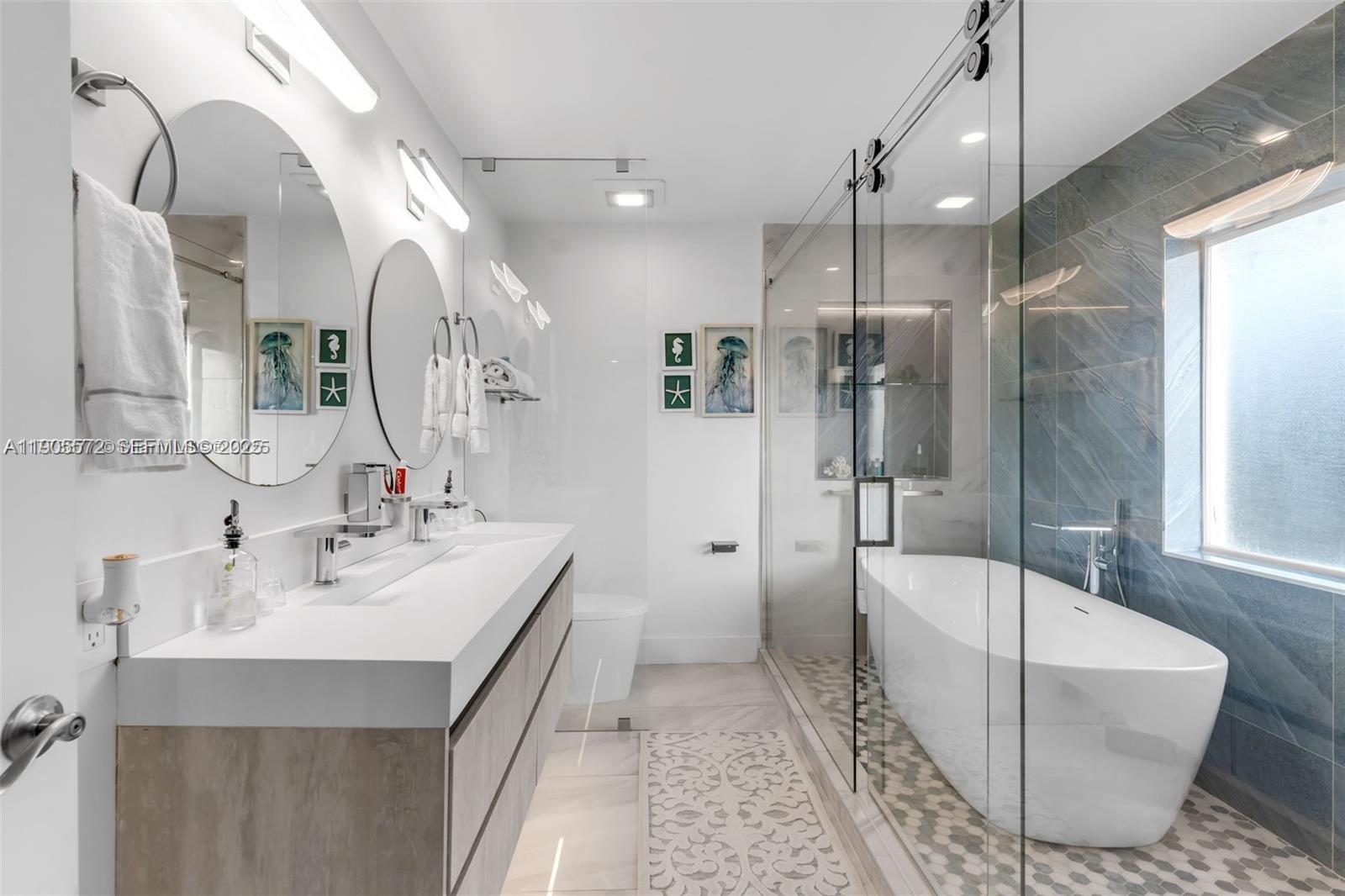 14206 Southwest 164th Terrace Miami, FL 33177 - Photo 30 of 58 a bathroom with a tub sink shower and mirror