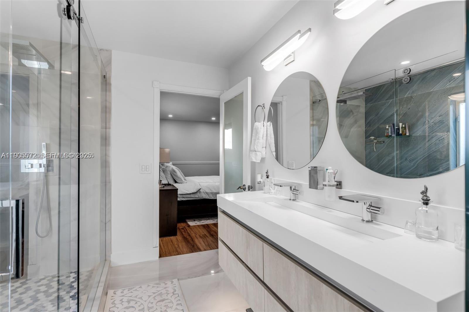 14206 Southwest 164th Terrace Miami, FL 33177 - Photo 31 of 58 a en suite bathroom with a double vanity sink and a mirror