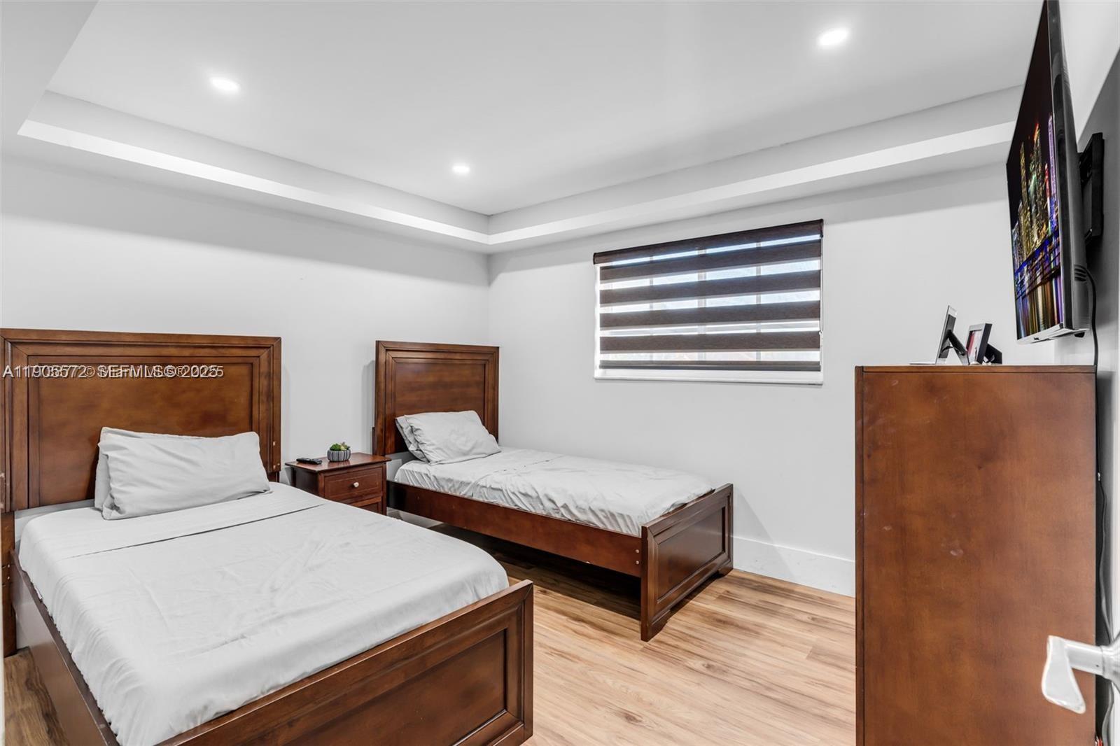 14206 Southwest 164th Terrace Miami, FL 33177 - Photo 32 of 58 a bedroom with two beds and painted walls