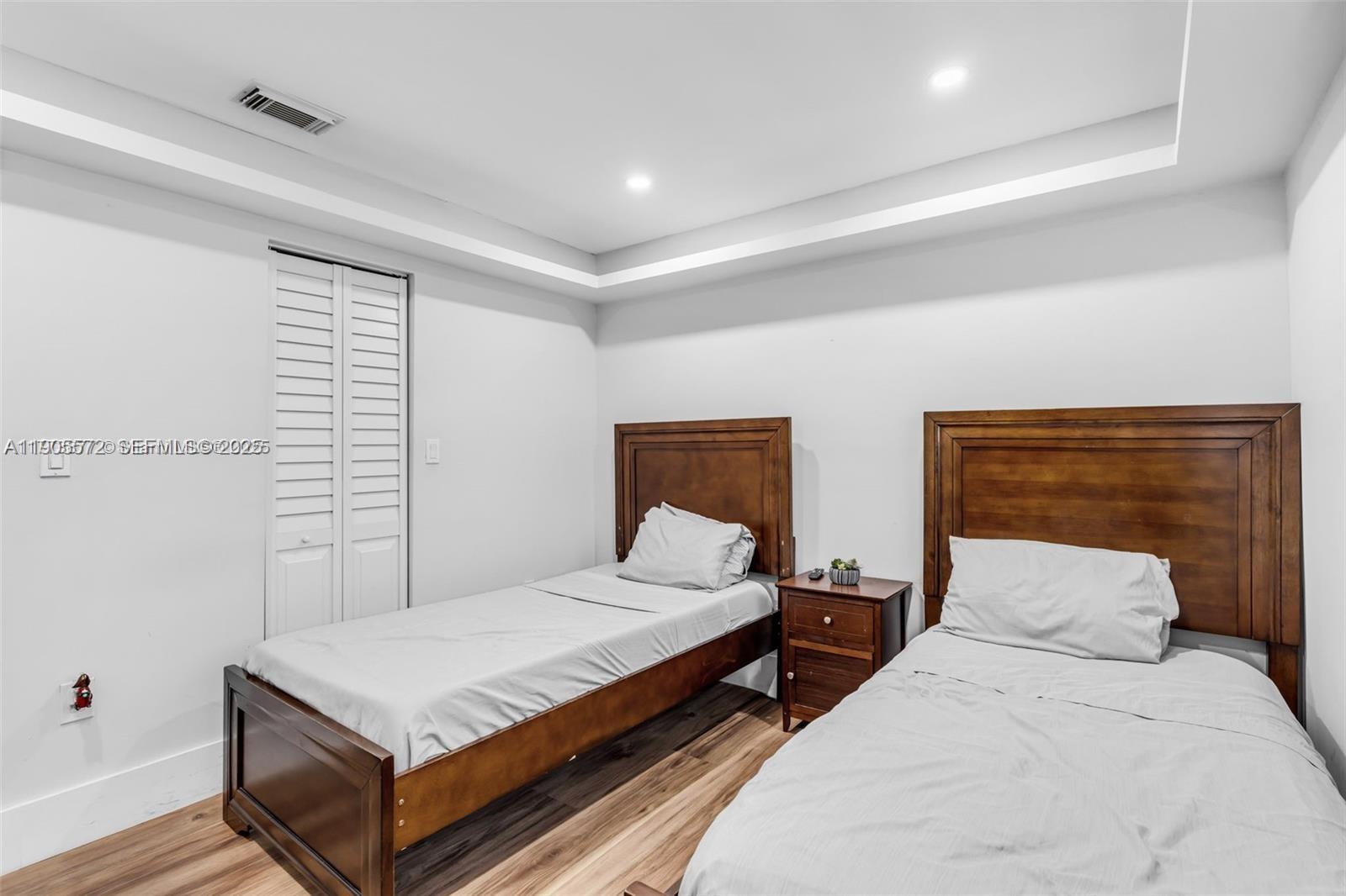 14206 Southwest 164th Terrace Miami, FL 33177 - Photo 33 of 58 a bedroom with two beds and a night stand