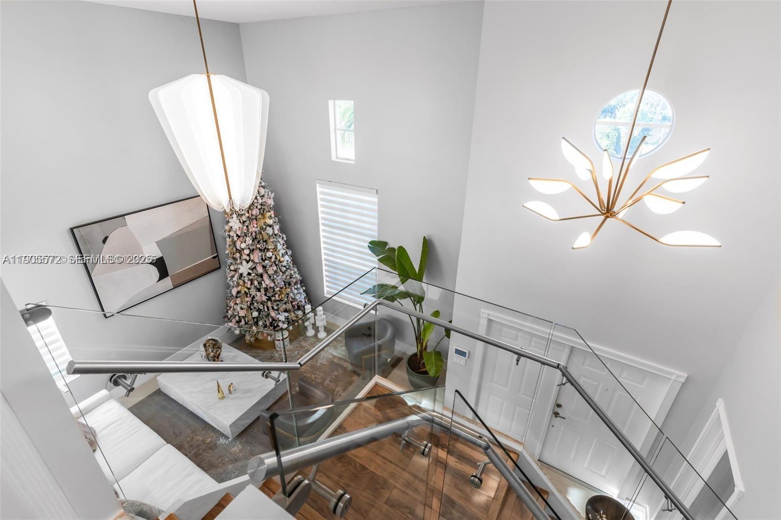 14206 Southwest 164th Terrace Miami, FL 33177 - Photo 36 of 58 a view of a room with furniture and a chandelier