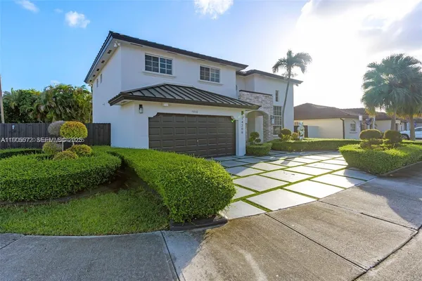 a front view of a house with a yard and garage