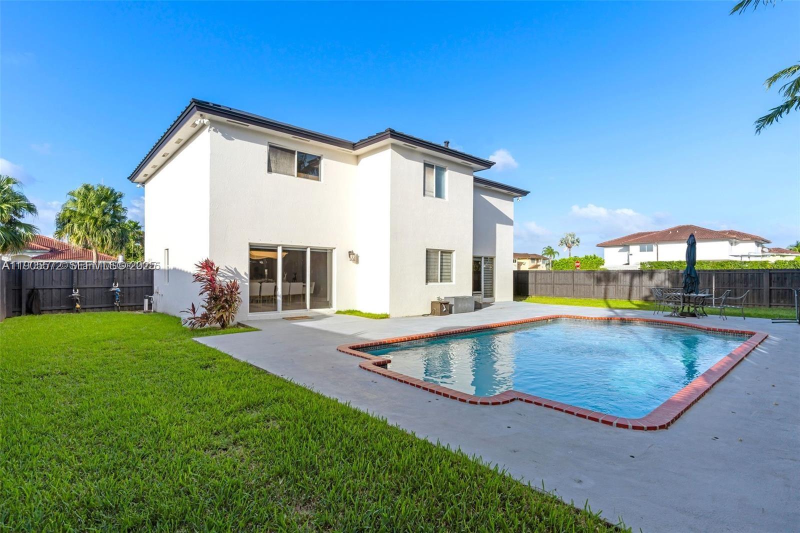 14206 Southwest 164th Terrace Miami, FL 33177 - Photo 43 of 58 a view of a house with backyard and swimming pool