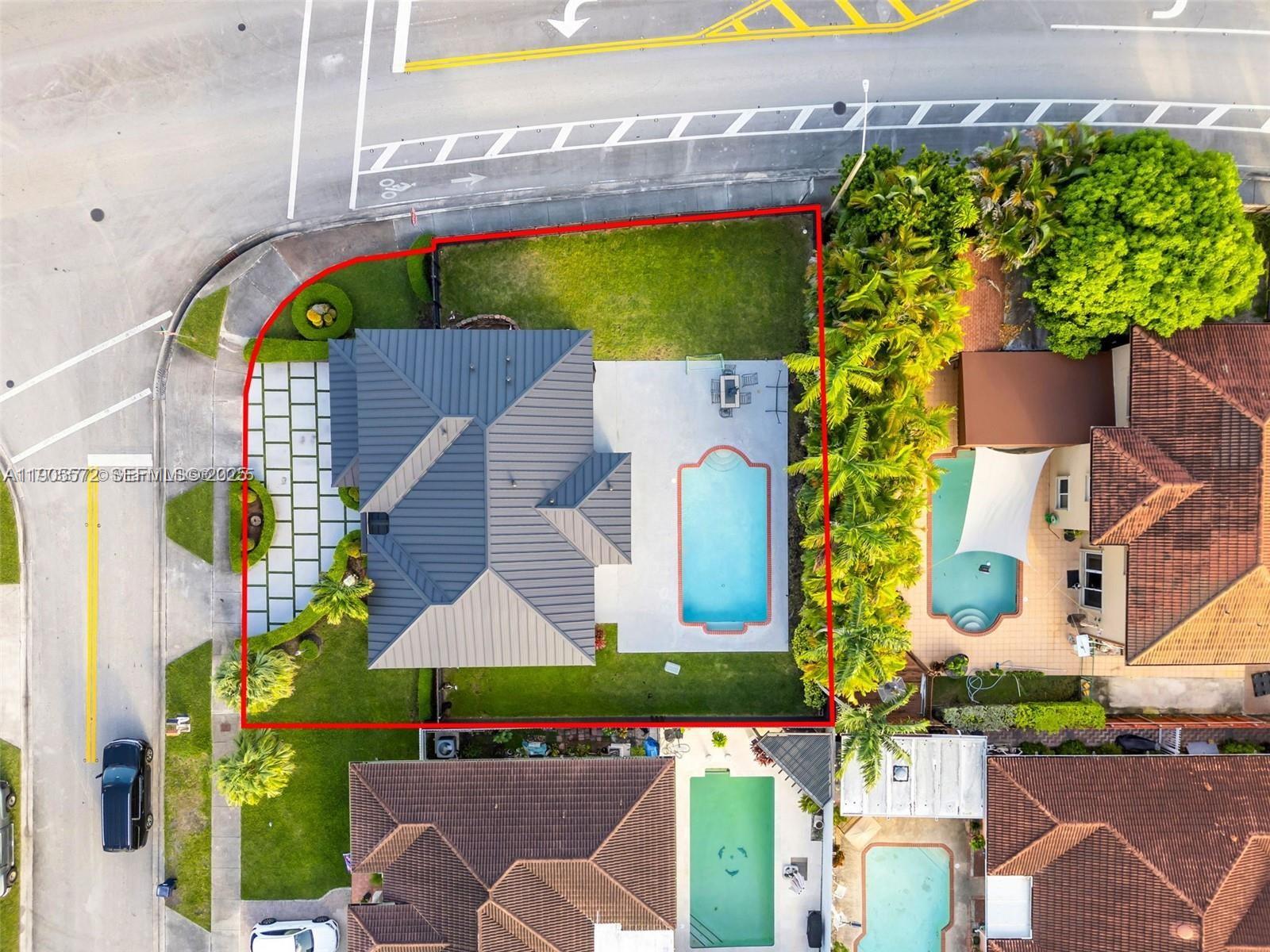 14206 Southwest 164th Terrace Miami, FL 33177 - Photo 57 of 58 an aerial view of a house with a yard and a fountain