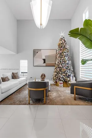 a living room with a couch and a chandelier