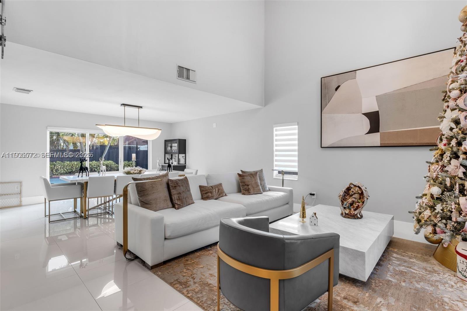 14206 Southwest 164th Terrace Miami, FL 33177 - Photo 7 of 58 a living room with furniture and a lamp