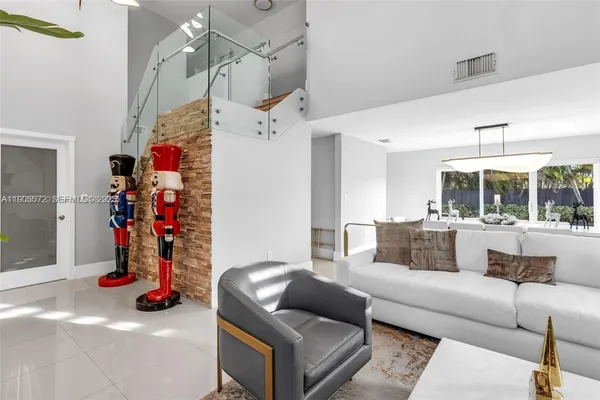 a living room with furniture and a gym equipment