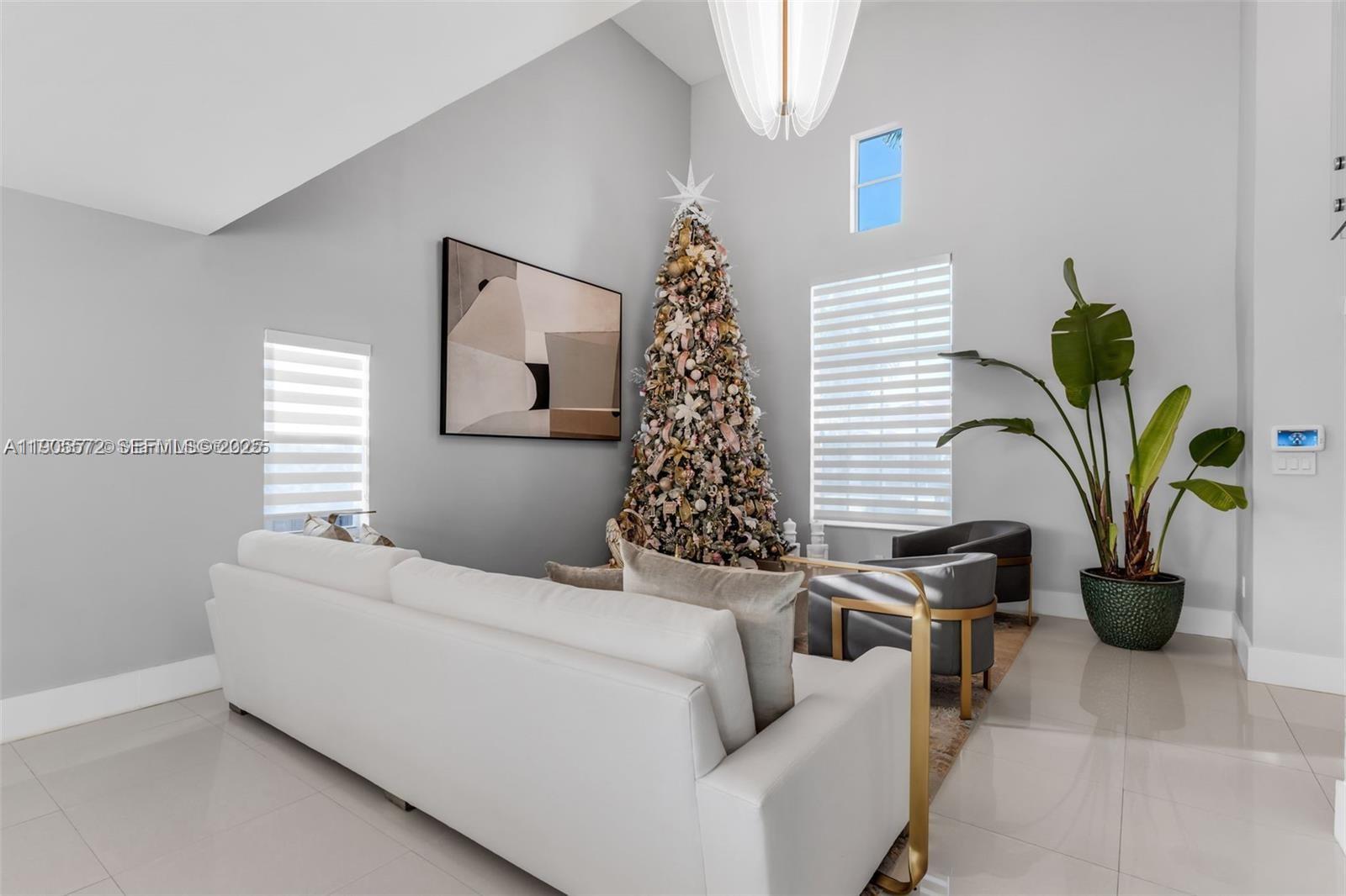 14206 Southwest 164th Terrace Miami, FL 33177 - Photo 9 of 58 a living room with furniture and a potted plant