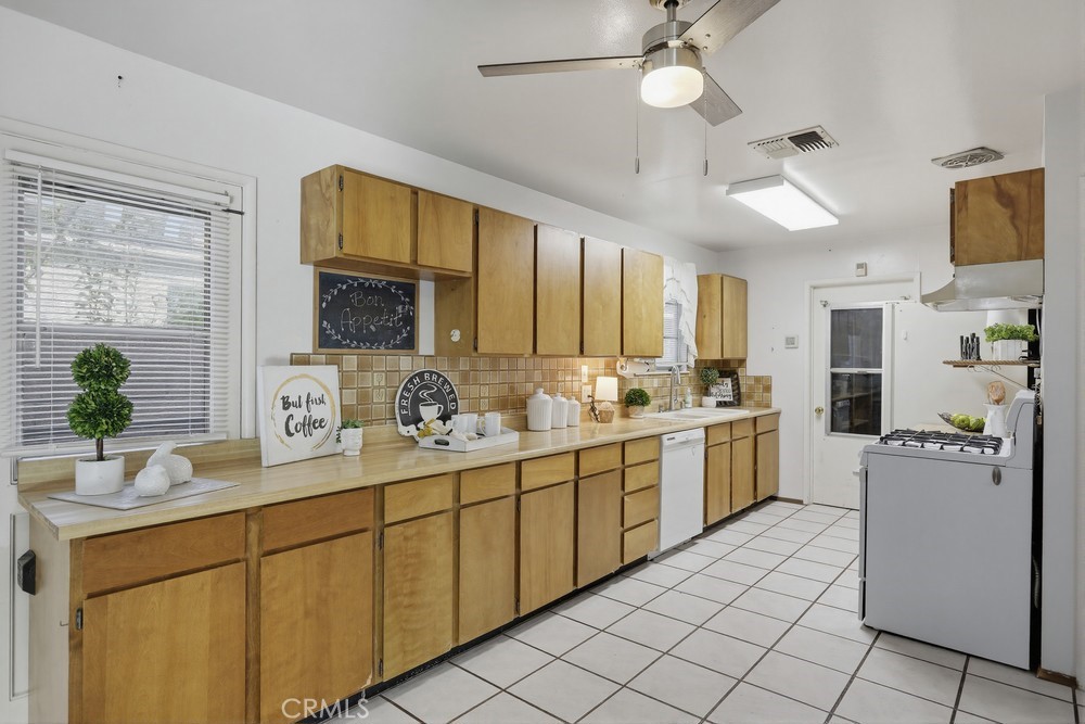 11681 Wasco Road Garden Grove, CA 92841 - Photo 20 of 58 a kitchen with a sink counter top space cabinets and stainless steel appliances