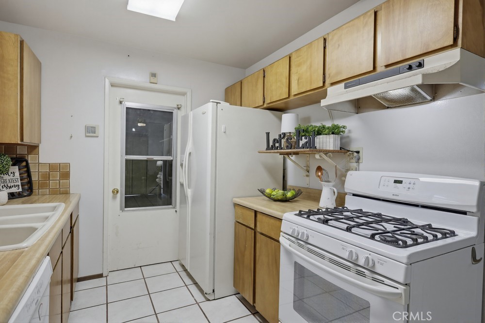 11681 Wasco Road Garden Grove, CA 92841 - Photo 21 of 58 a kitchen with stainless steel appliances granite countertop a stove a refrigerator and a sink
