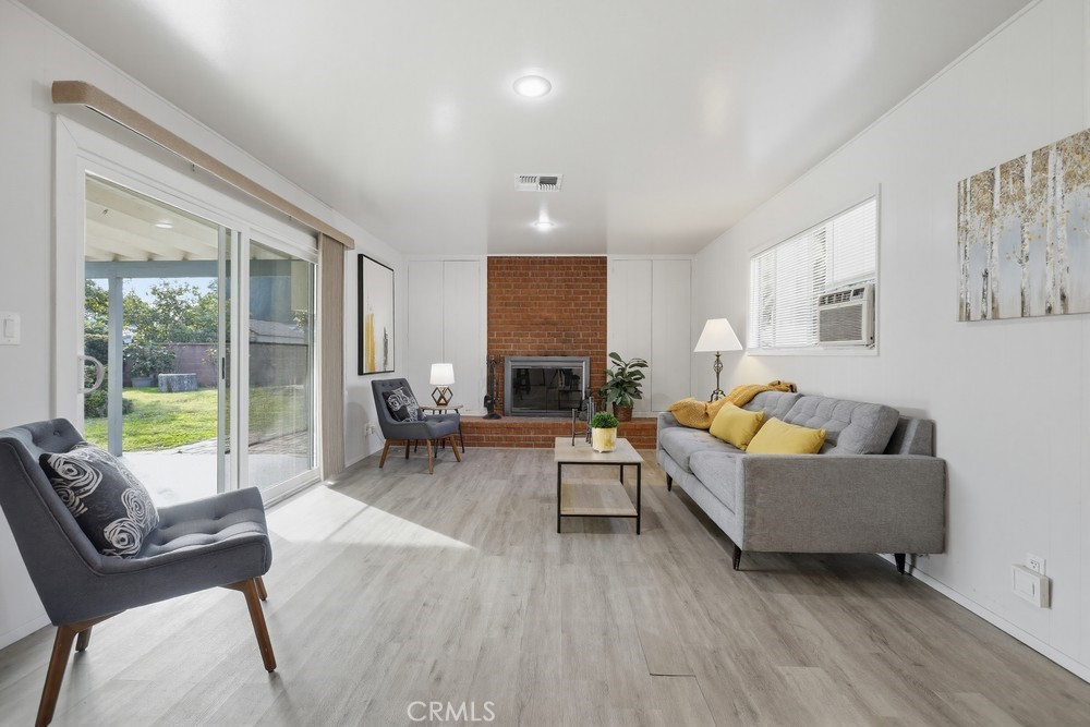 11681 Wasco Road Garden Grove, CA 92841 - Photo 23 of 58 a living room with furniture and a fireplace