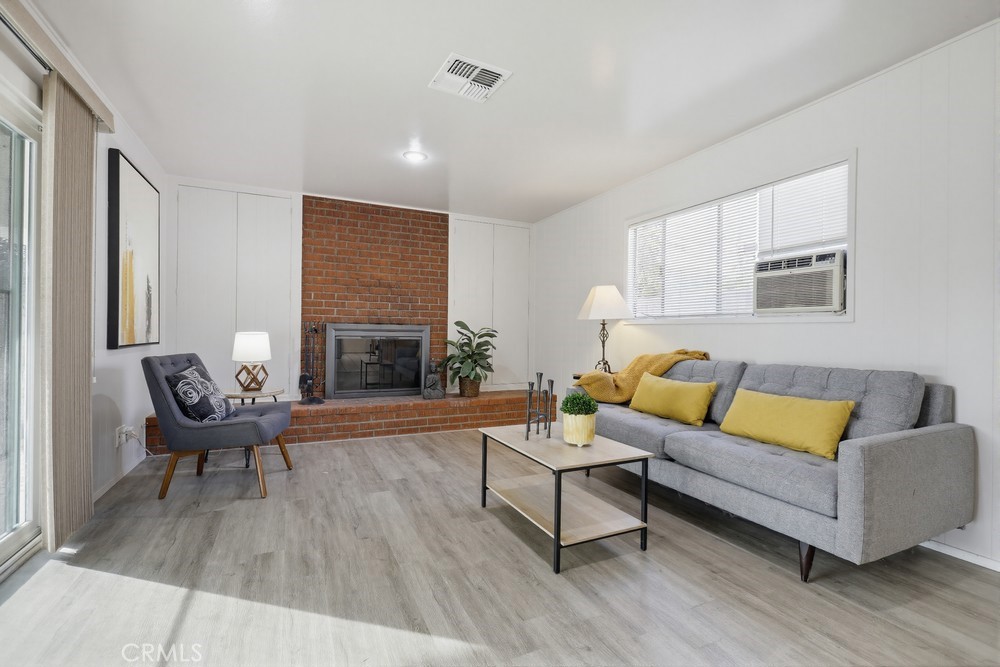 11681 Wasco Road Garden Grove, CA 92841 - Photo 24 of 58 a living room with furniture and a fireplace