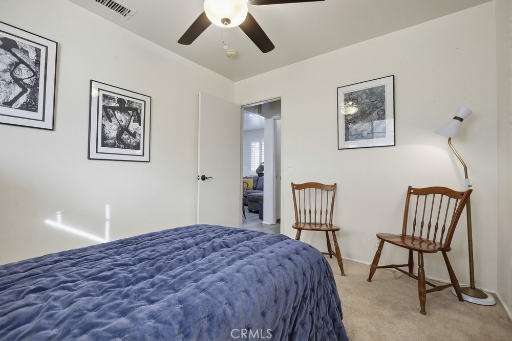 11681 Wasco Road Garden Grove, CA 92841 - Photo 32 of 58 a bedroom with a bed and a chandelier