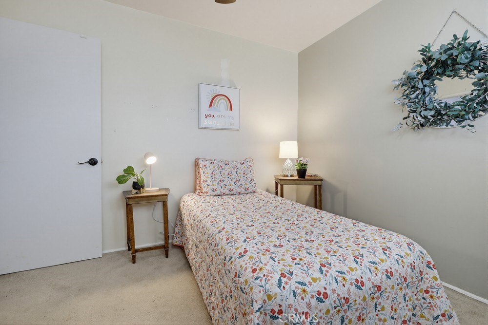 11681 Wasco Road Garden Grove, CA 92841 - Photo 36 of 58 a bedroom with a bed and a potted plant