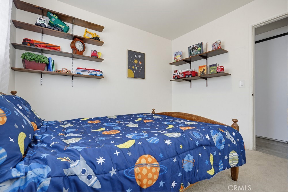 11681 Wasco Road Garden Grove, CA 92841 - Photo 39 of 58 a bedroom with a bed and a painting on the wall