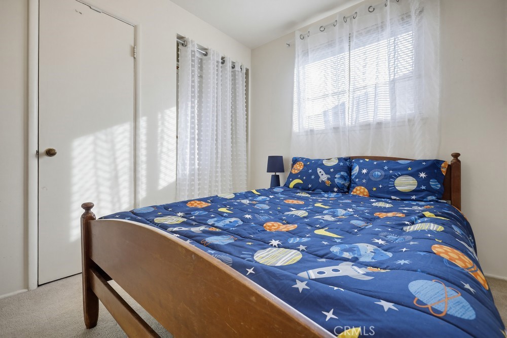 11681 Wasco Road Garden Grove, CA 92841 - Photo 40 of 58 a bed sitting in a bedroom next to a window
