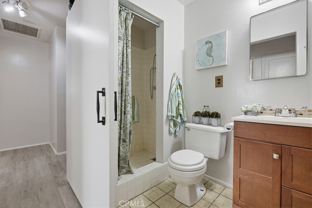 11681 Wasco Road Garden Grove, CA 92841 - Photo 41 of 58 a bathroom with a toilet a sink and shower