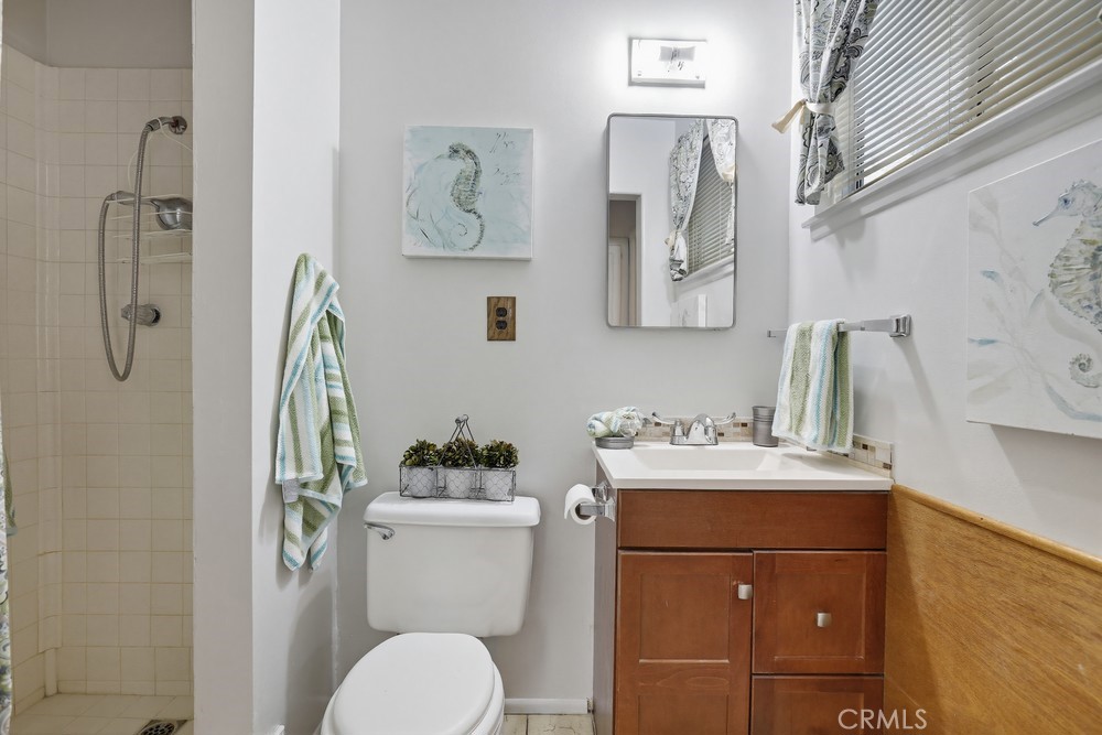 11681 Wasco Road Garden Grove, CA 92841 - Photo 42 of 58 a bathroom with a sink toilet and vanity