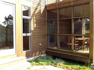 6 Cooper Circle Truro, MA 02666 - Photo 15 of 24 a backyard of a house with barbeque oven and glass windows