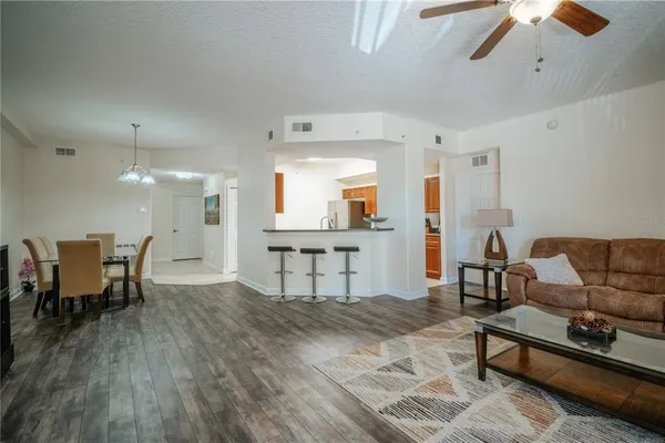 a living room with furniture and a wooden floor