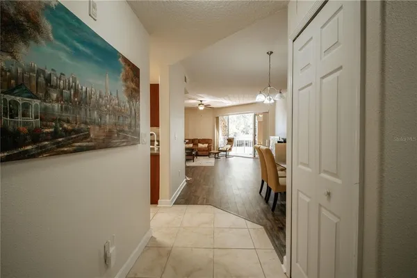 a view of a hallway and a livingroom with furniture