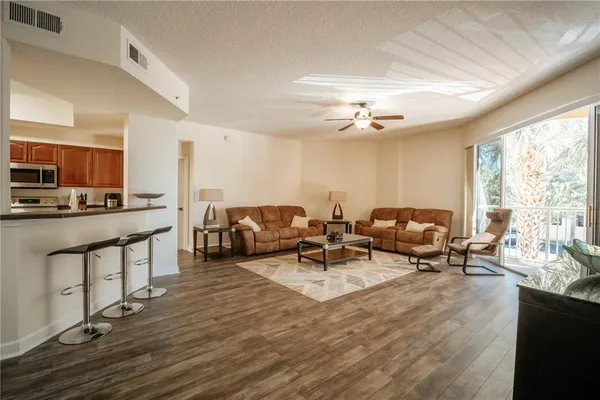 a living room with fireplace furniture and a large window