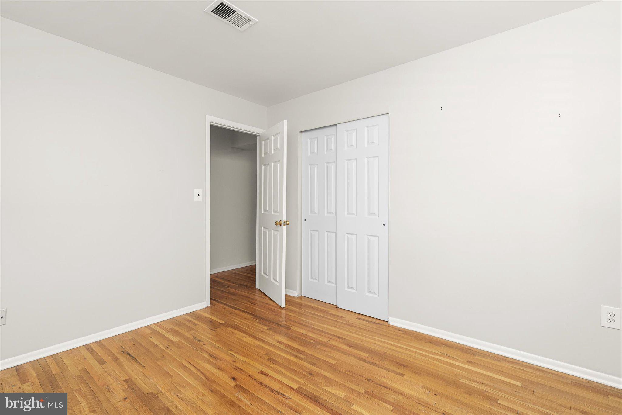 201 Silver Court Hamilton, NJ 08690 - Photo 11 of 27 a view of an empty room with wooden floor