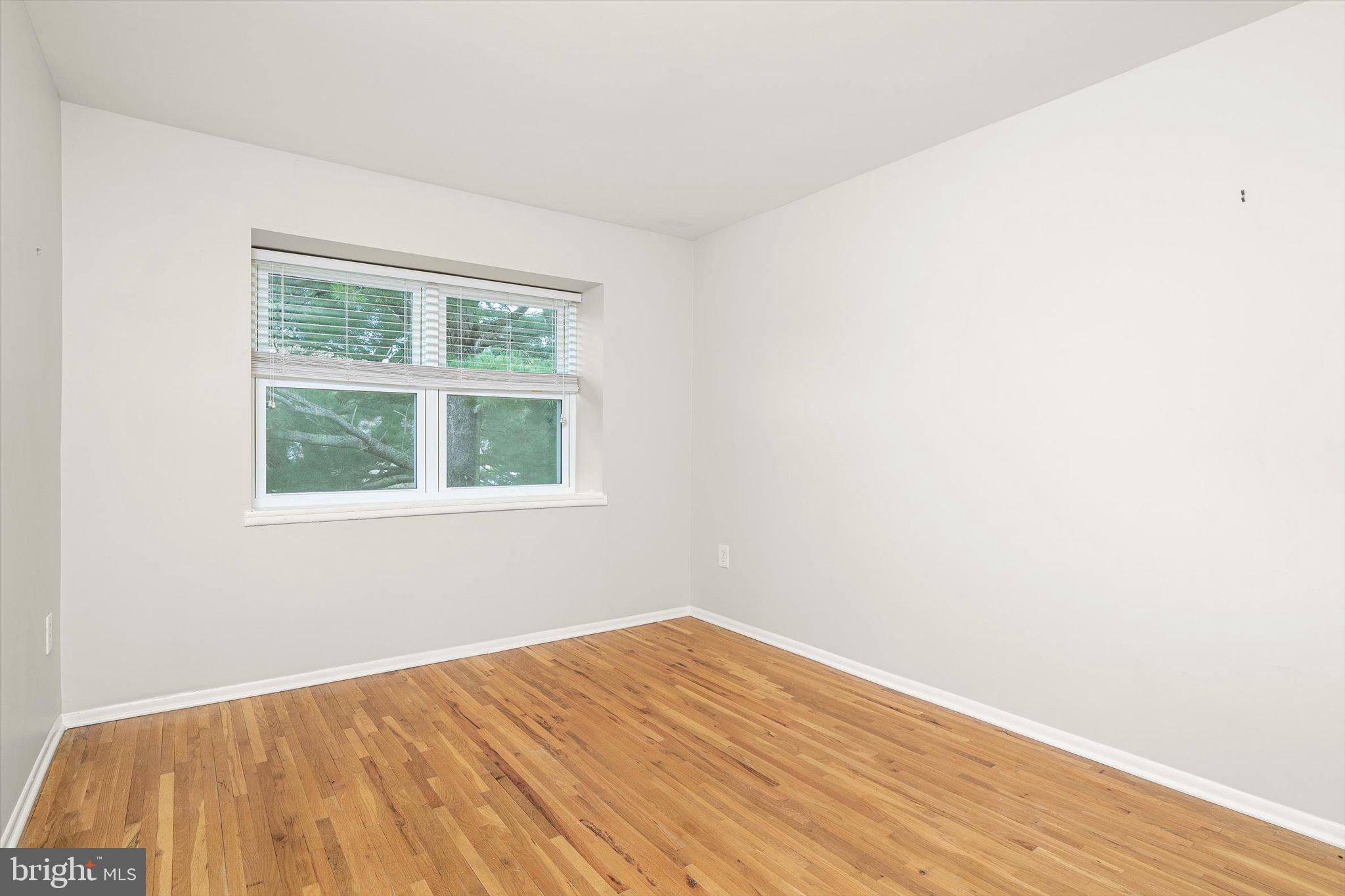 201 Silver Court Hamilton, NJ 08690 - Photo 12 of 27 an empty room with wooden floor and windows