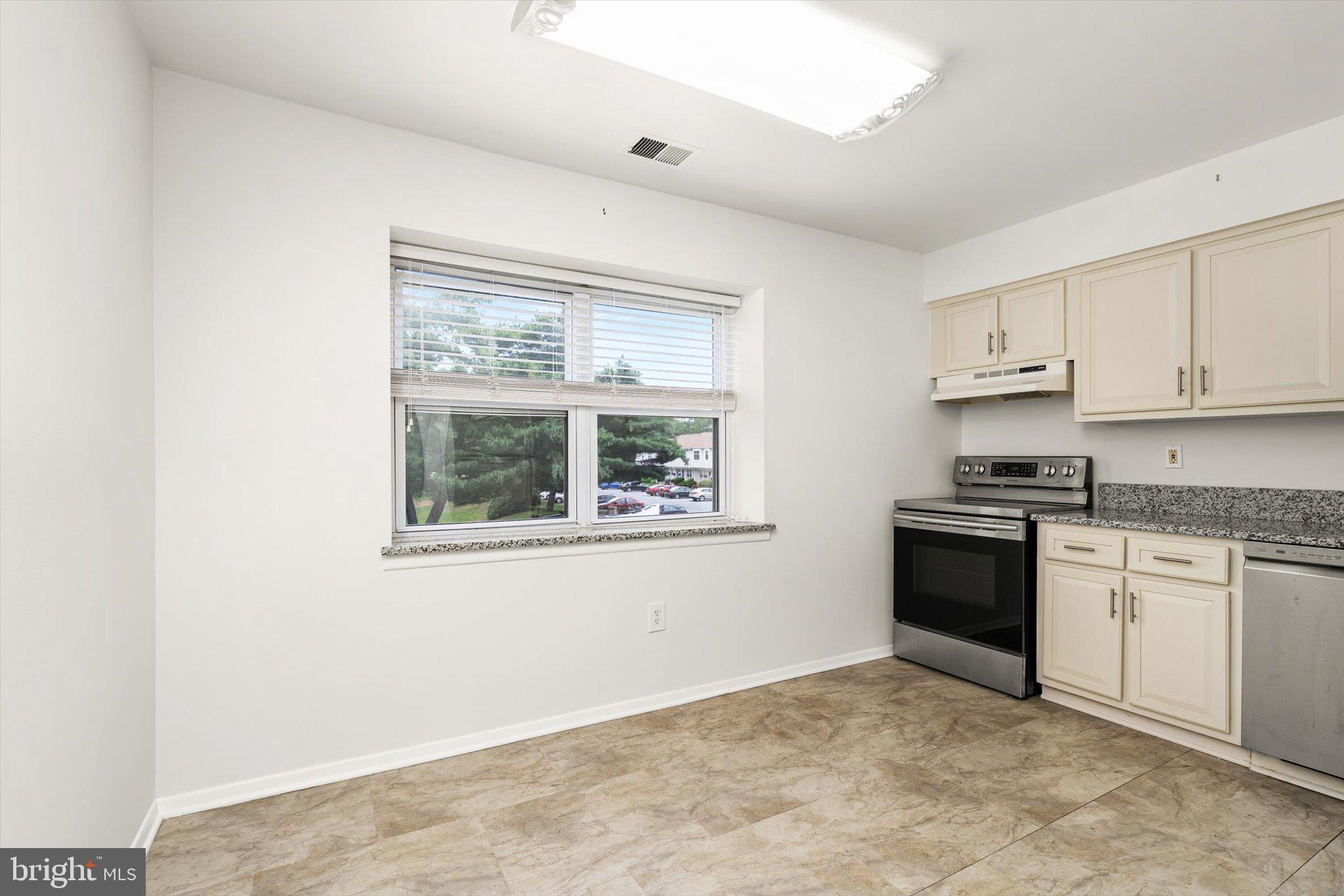 201 Silver Court Hamilton, NJ 08690 - Photo 18 of 27 a kitchen with granite countertop a stove a sink and a refrigerator