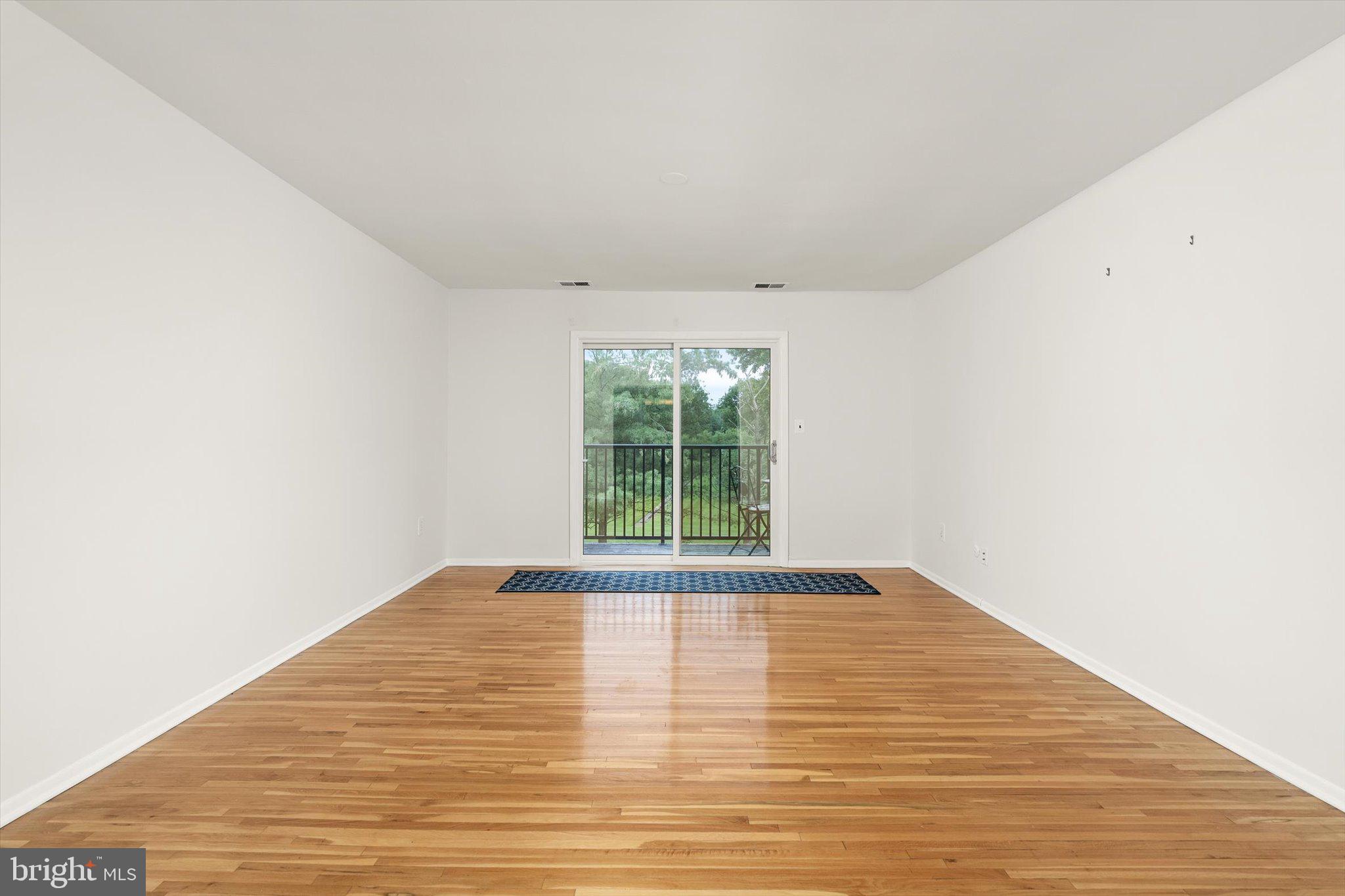 201 Silver Court Hamilton, NJ 08690 - Photo 22 of 27 a view of an empty room with wooden floor and a window