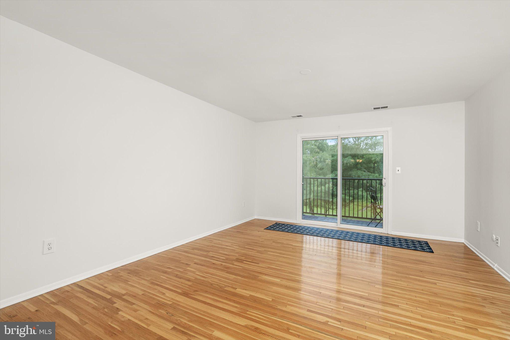 201 Silver Court Hamilton, NJ 08690 - Photo 23 of 27 a view of an empty room with wooden floor and a window