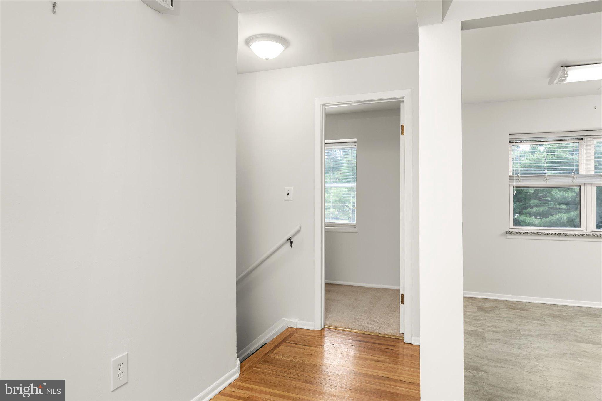 201 Silver Court Hamilton, NJ 08690 - Photo 25 of 27 a view of a hallway with wooden floor and a bathroom