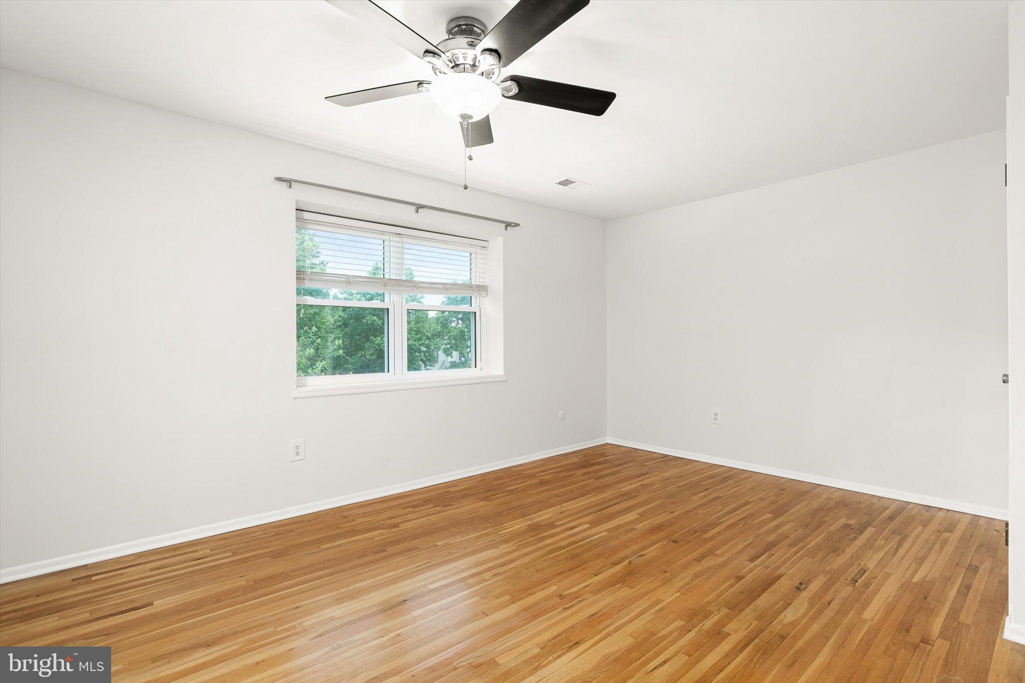 201 Silver Court Hamilton, NJ 08690 - Photo 6 of 27 an empty room with a window and a fan