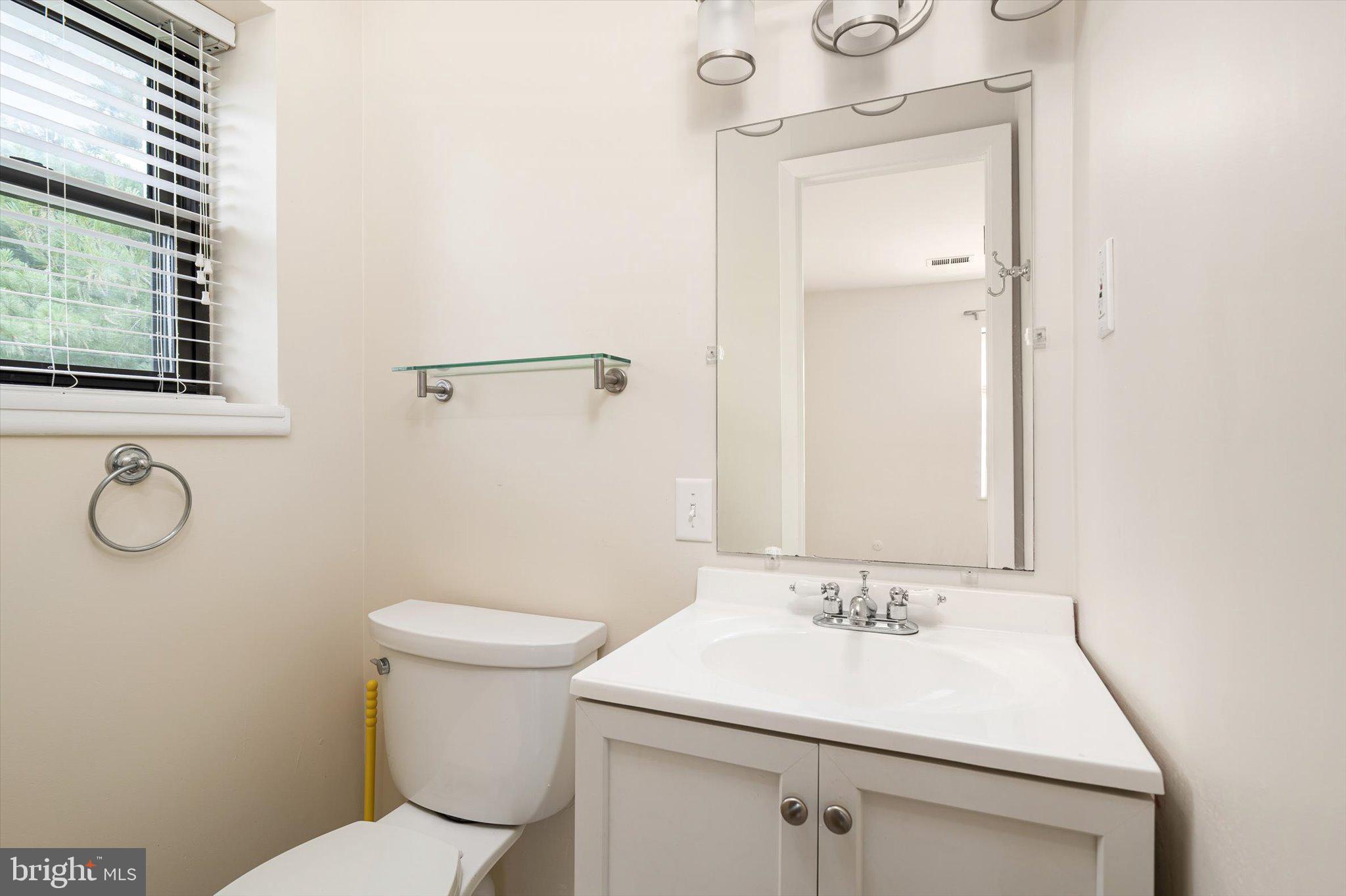 201 Silver Court Hamilton, NJ 08690 - Photo 10 of 27 a bathroom with a sink a toilet and mirror